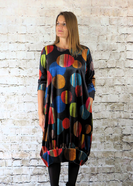 The gathered hem dress is made from a soft stretch black viscose velvet fabric, with a beautiful all over multi colour design. Perfect for any autumn winter occasion, from a wedding Mother of the Bride, Mother of the Groom, Wedding Guest to a party or everyday wear. This dress will take you from day to night with effortless style and elegance.