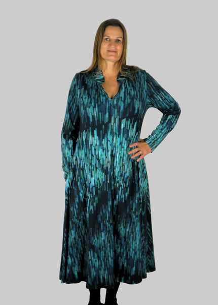 This V Collar dress is made from a soft feel jersey fabric, with an all over shades of blue print. Perfect for any autumn / winter occasion from a wedding, mother of the bride, mother of the groom to a party or everyday wear. This dress will take you from day to night with effortless style and elegance. Available in Abstract Aqua, Fuchsia & Green,&  Fusion Aqua & Gold.