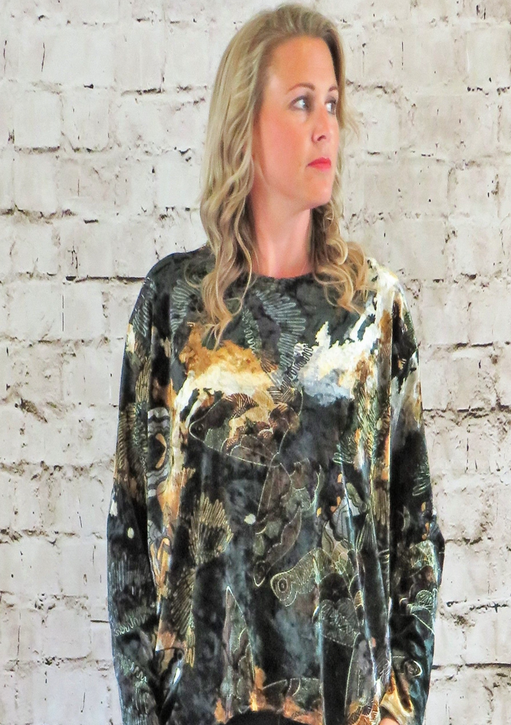 The wide top is made from a soft stretch green viscose velvet fabric, with a beautiful all over butterfly design. Perfect for any autumn winter occasion from a party to everyday wear. This top will take you from day to night with effortless style and elegance.