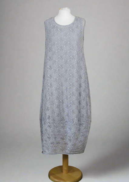 This sleeveless dress is made from a silver sheer fabric with a beautiful all over shell design, and a soft viscose lining. Perfect for any spring summer occasion, from a wedding - mother of the bride, mother of the groom and wedding guest to everyday wear. This dress will take you from day to night with effortless style and elegance. A matching shrug is available
