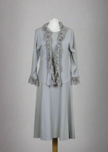 This sleeveless dress is made from a soft silver crepe fabric. Perfect for any spring summer occasion, from a wedding - mother of the bride, mother of the groom and wedding guest to everyday wear. This dress will take you from day to night with effortless style and elegance. A matching shrug is available.