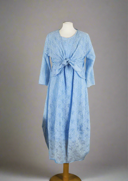 This sleeveless dress is made from a blue sheer fabric with a beautiful all over shell design, and a soft viscose lining. Perfect for any spring summer occasion, from a wedding - mother of the bride, mother of the groom and wedding guest to everyday wear. This dress will take you from day to night with effortless style and elegance. A matching shrug is available.