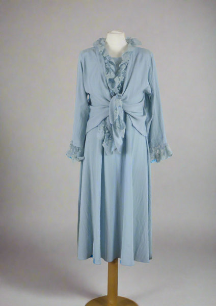 This sleeveless dress is made from a soft blue crepe fabric. Perfect for any spring summer occasion, from a wedding - mother of the bride, mother of the groom and wedding guest to everyday wear. This dress will take you from day to night with effortless style and elegance. A matching shrug is available.