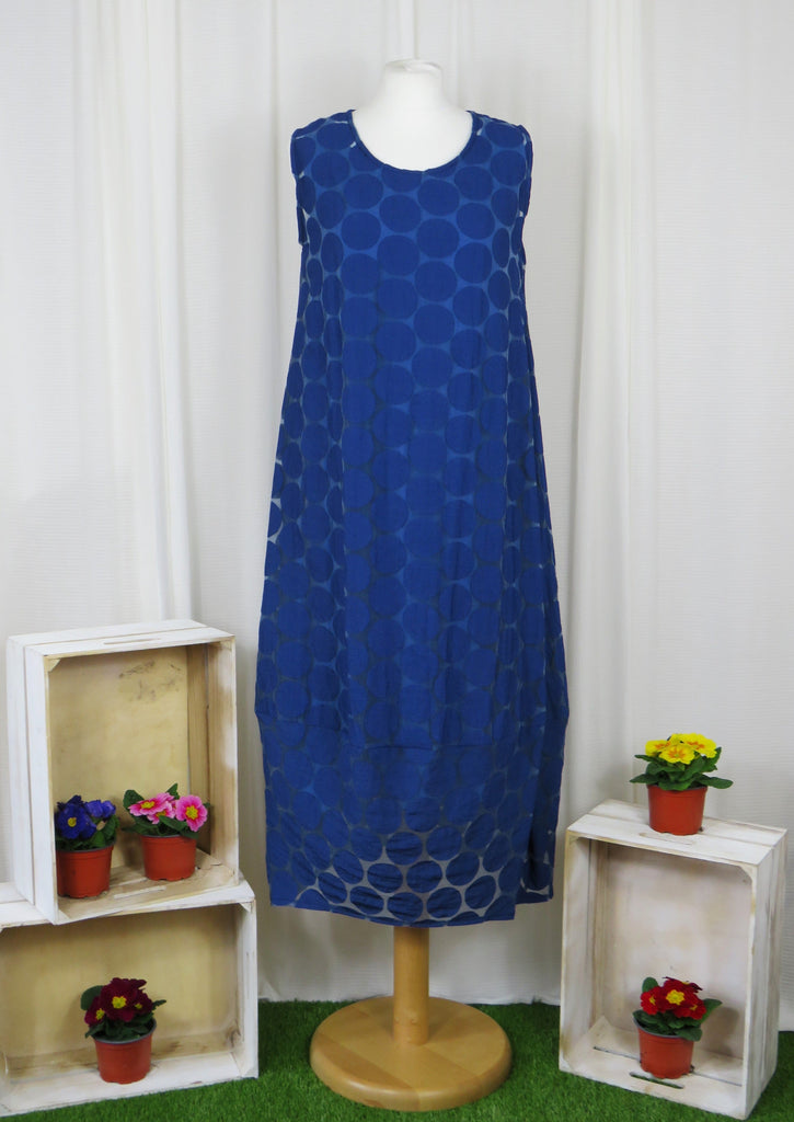 This sleeveless dress is made from a navy sheer fabric with a beautiful all over spot design, and a soft viscose lining. Perfect for any spring summer occasion, from a wedding - mother of the bride, mother of the groom and wedding guest to everyday wear. This dress will take you from day to night with effortless style and elegance. A matching shrug is available.