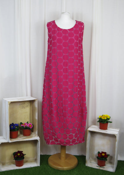 This sleeveless dress is made from a cerise sheer fabric with a beautiful all over spot design, and a soft viscose lining. Perfect for any spring summer occasion, from a wedding - mother of the bride, mother of the groom and wedding guest to everyday wear. This dress will take you from day to night with effortless style and elegance. A matching shrug is available. 