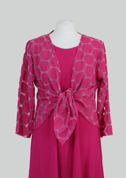The shrug is made from a soft sheer cerise fabric with an  all over spot design. Perfect for any spring summer occasion, from a wedding - mother of the bride, mother of the groom and wedding guest to everyday wear. This shrug will take you from day to night with effortless style and elegance. Matching dresses available.