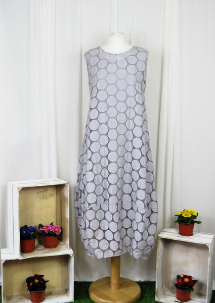 This sleeveless dress is made from a silver sheer fabric with a beautiful all over spot design, with a soft viscose lining. Perfect for any spring summer occasion, from a wedding - mother of the bride, mother of the groom and wedding guest to everyday wear. This dress will take you from day to night with effortless style and elegance. A matching shrug is available.