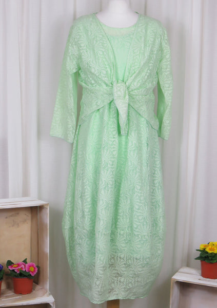 This sleeveless dress is made from a green sheer fabric with a beautiful all over shell design, and a soft viscose lining. Perfect for any spring summer occasion, from a wedding - mother of the bride, mother of the groom and wedding guest to everyday wear. This dress will take you from day to night with effortless style and elegance. A matching shrug is available.