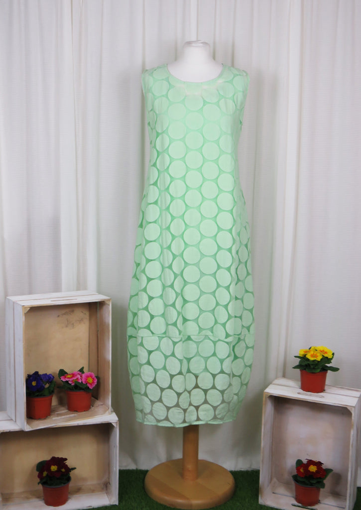 This sleeveless dress is made from a green sheer fabric with a beautiful all over spot design, and a soft viscose lining. Perfect for any spring summer occasion, from a wedding - mother of the bride, mother of the groom and wedding guest to everyday wear. This dress will take you from day to night with effortless style and elegance. A matching shrug is available.
