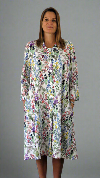 This coat dress is made from a soft feel white cotton fabric, with a beautiful all over flower print. Perfect for any spring summer occasion, from a wedding - mother of the bride, mother of the groom and wedding guest to everyday wear. This coat dress will take you from day to night with effortless style and elegance.