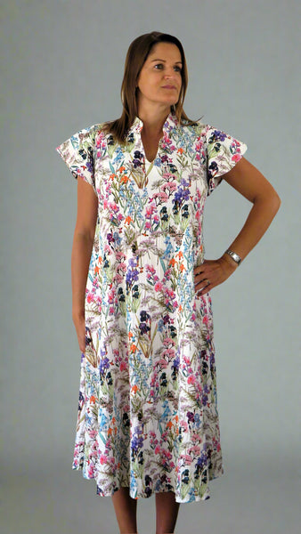 This dress has flutter sleeves and is made from a soft feel white cotton fabric, with a beautiful all over flower print. Perfect for any spring summer occasion, from a wedding - mother of the bride, mother of the groom and wedding guest to everyday wear. This dress will take you from day to night with effortless style and elegance.