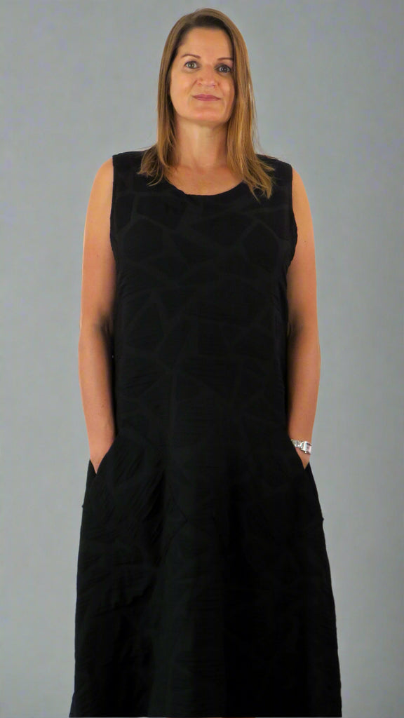This black sleeveless dress is made from a soft feel tortoise shell fabric. Perfect for any spring summer occasion, from a wedding to everyday wear. This dress will take you from day to night with effortless style and elegance.