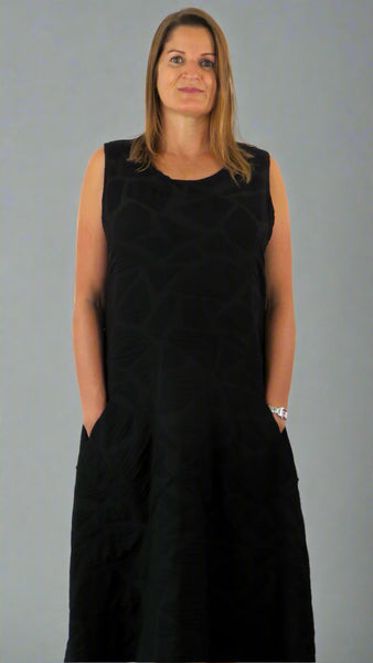 This black sleeveless dress is made from a soft feel tortoise shell fabric. Perfect for any spring summer occasion, from a wedding to everyday wear. This dress will take you from day to night with effortless style and elegance.