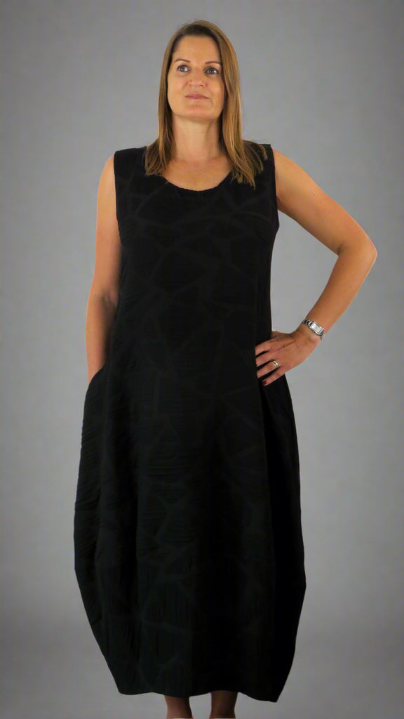 This black sleeveless dress is made from a soft feel Tortoise shell fabric. Perfect for any spring summer occasion, from a wedding to everyday wear. This dress will take you from day to night with effortless style and elegance.