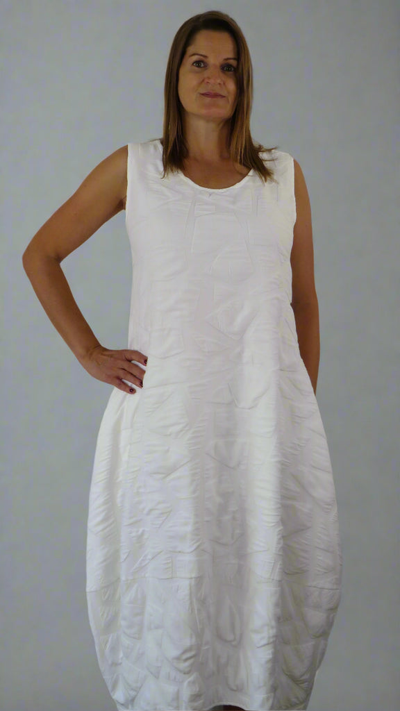 This white sleeveless dress is made from a soft feel tortoise shell fabric. Perfect for any spring summer occasion, from a wedding to everyday wear. This dress will take you from day to night with effortless style and elegance.