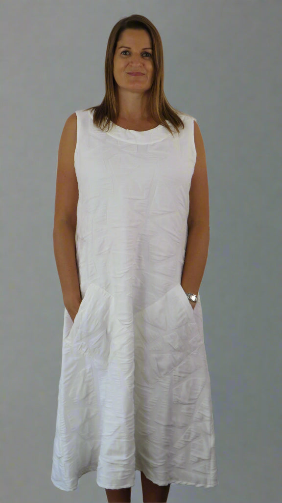This white sleeveless dress is made from a soft feel tortoise shell fabric. Perfect for any spring summer occasion, from a wedding to everyday wear. This dress will take you from day to night with effortless style and elegance.