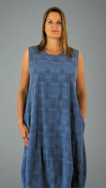 This sleeveless hem dress is made from a soft blue linen, with an all over cross stitch design. Perfect for any spring summer occasion or everyday wear. This dress will take you from day to night with effortless style and elegance.