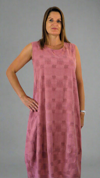 This sleeveless hem dress is made from a soft pink linen, with an all over cross stitch design. Perfect for any spring summer occasion or everyday wear. This dress will take you from day to night with effortless style and elegance.