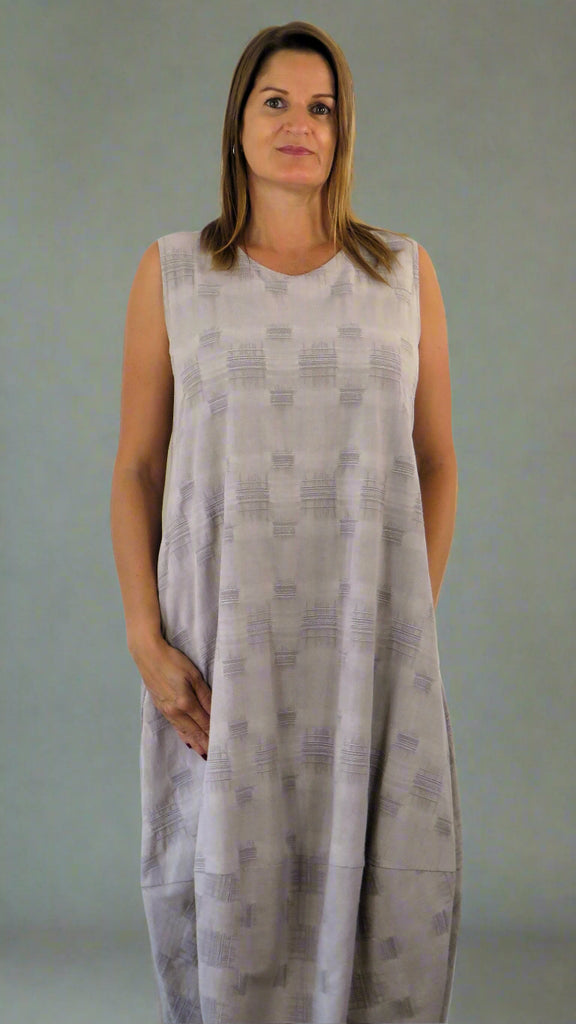 This sleeveless hem dress is made from a soft stone linen, with an all over cross stitch design. Perfect for any spring summer occasion or everyday wear. This dress will take you from day to night with effortless style and elegance.