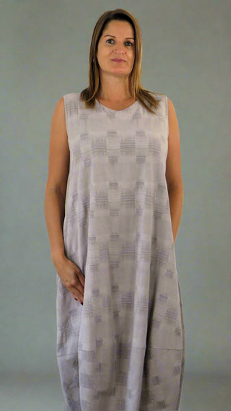 This sleeveless hem dress is made from a soft stone linen, with an all over cross stitch design. Perfect for any spring summer occasion or everyday wear. This dress will take you from day to night with effortless style and elegance.