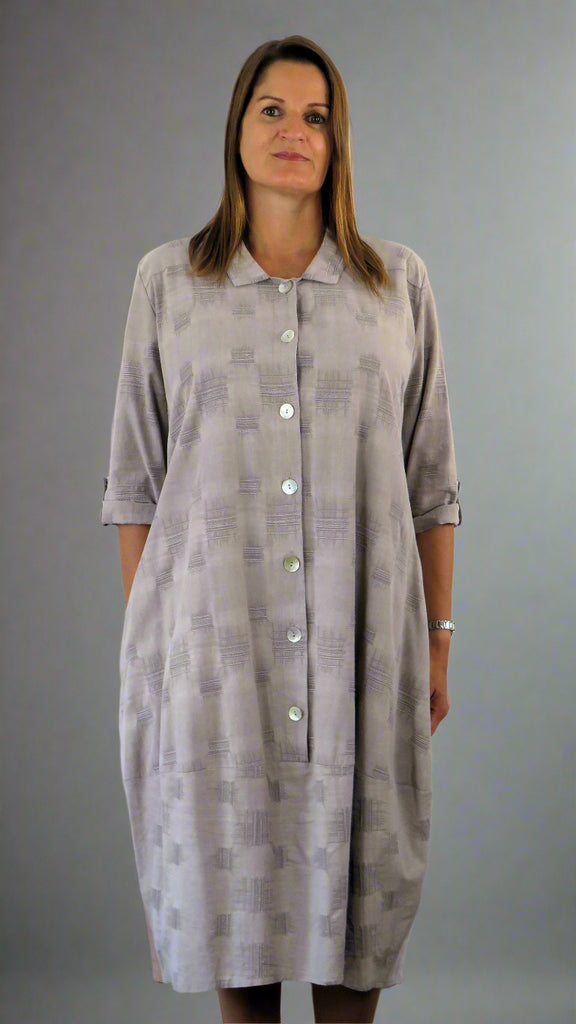 This button front dress has pockets and is made from a soft stone linen, with an all over cross stitch design. Perfect for any spring summer occasion or everyday wear. This dress will take you from day to night with effortless style and elegance.