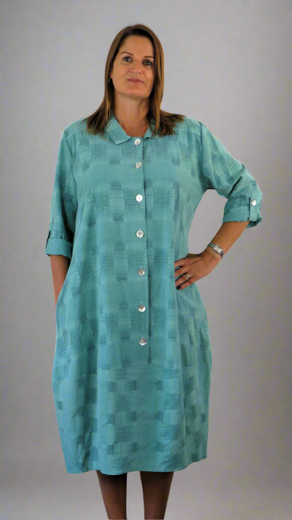 This button front dress has pockets and is made from a soft green linen, with an all over cross stitch design. Perfect for any spring summer occasion or everyday wear. This dress will take you from day to night with effortless style and elegance.