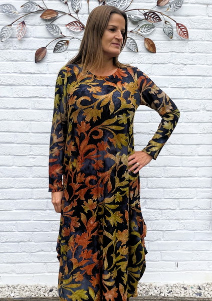 The dress is made from a soft feel orange jersey devore fabric, with an all over design. The dress has a hitch up hem on both sides, which can be buttoned up or let down for a longer length. Perfect for any autumn winter occasion, from a wedding Mother of the Bride, Mother of the Groom, Wedding Guest to a party or everyday wear. This dress will take you from day to night with effortless style and elegance.
