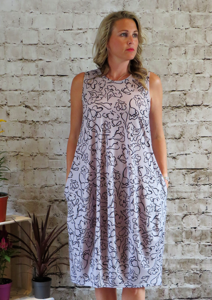 This sleeveless bell dress is made from a soft feel silver Jersey fabric, with a beautiful all over black print. Perfect for any spring summer  occasion or everyday wear. This dress will take you from day to night with effortless style and elegance