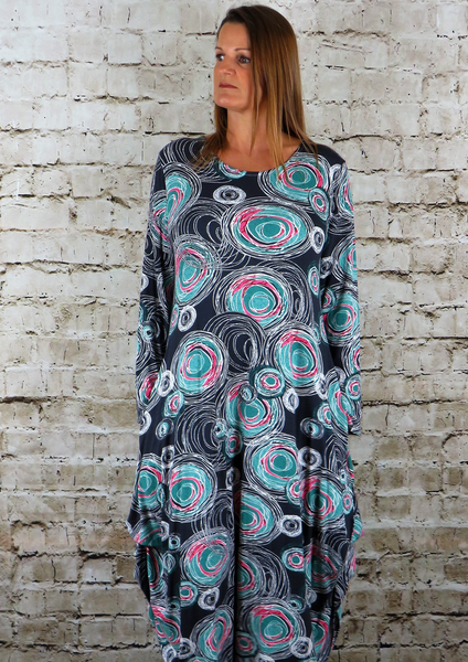 This dress is made from a soft feel Jersey fabric, with an all over multi colour print. The dress has a hitch up hem on both sides, which can be buttoned up or let down for a longer length. Perfect for any spring summeroccasion or everyday wear. This dress will take you from day to night with effortless style and elegance. Available in Black, Lime and Sand.