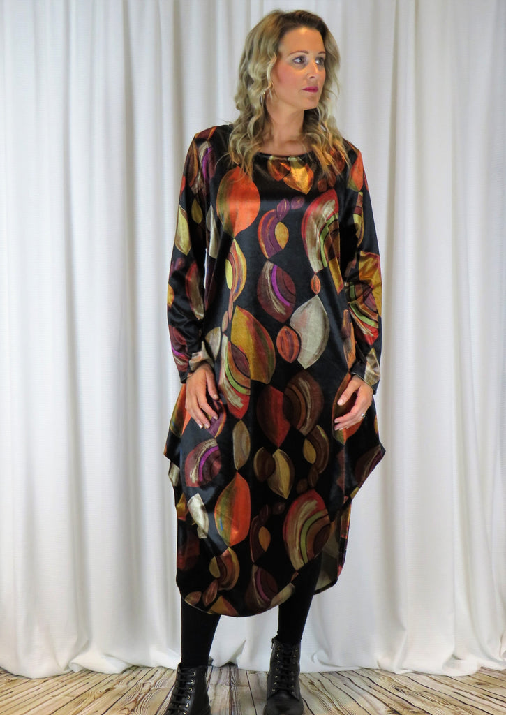 The dress is made from a soft stretch viscose velvet fabric,  with a beautiful all over brown autumnal design. The dress has a hitch up hem on both sides, which can be buttoned up or let down for a longer length. Perfect for any autumn winter occasion, from a wedding Mother of the Bride, Mother of the Groom, Wedding Guest to a party or everyday wear. This dress will take you from day to night with effortless style and elegance.